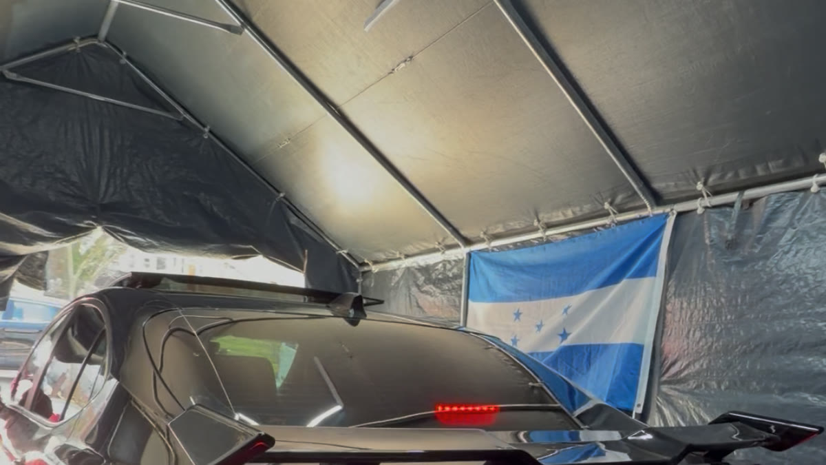 Black hatchback with finished rear glass under the work canopy